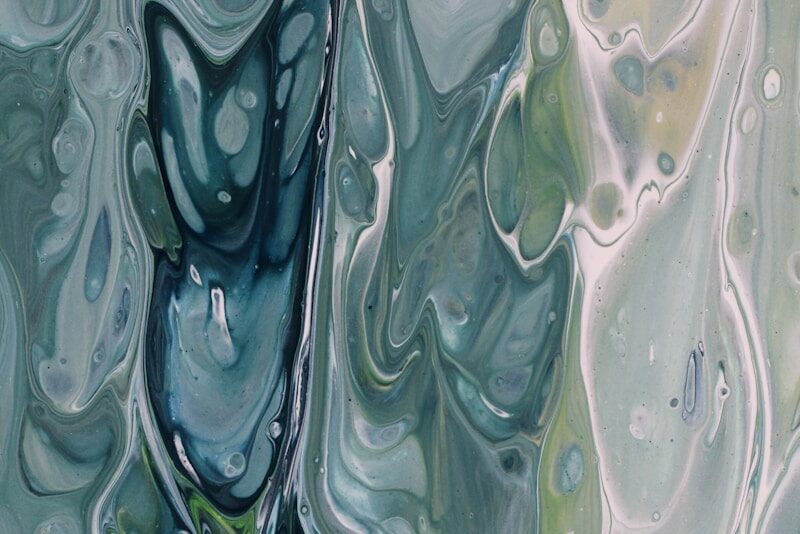 an abstract painting of blue and green colors