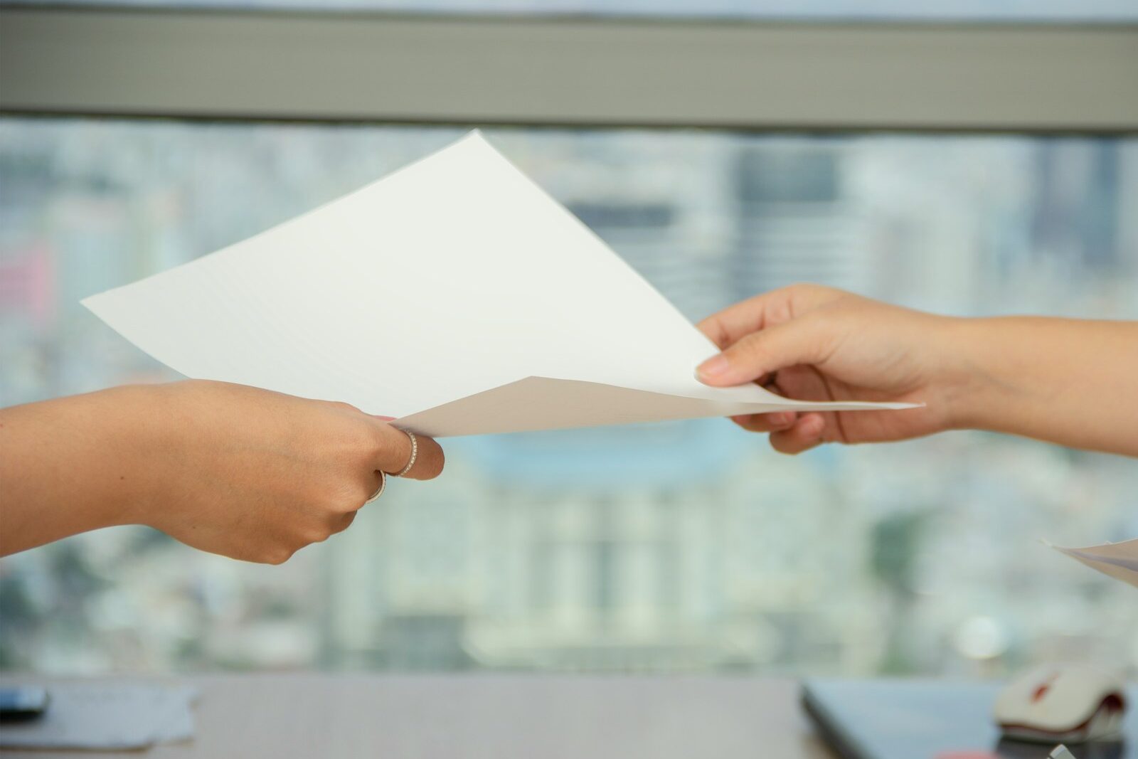person handing over paper